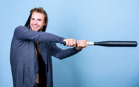 Bully mood. Bad boy concept. Man handsome bully guy with baseball bat. Strong and confident. Sport equipment. Sportsman strong macho looks threatening with bat. Aggression masculinity strong temperの写真素材