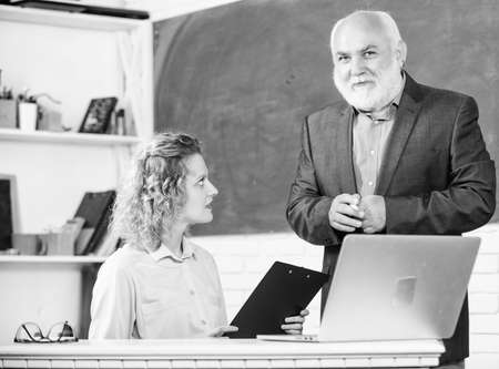Modern school. Lecturer educator sharing his knowledge. Communicate clearly and effectively. Work in education. Man mature school teacher and girl student with laptop. High school college university