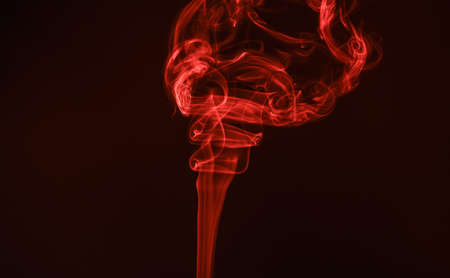 Wisp of smoke. Abstract wisp maroon background. Red smoke spiraled. Vapor flow. Vaporizingの写真素材