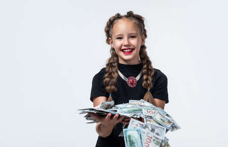pretty teen girl with pigtails has lots of money isolated on white, cashの写真素材