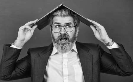 Lot of information. Online madness. Provide accurate current information. Teacher hold laptop surfing internet. Bearded man laptop on head. Interesting information. School lifehack. Homeschoolingの写真素材