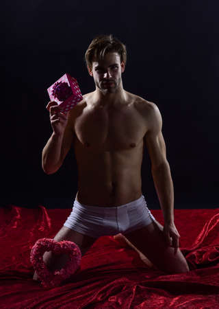 голый бокс muscular and athletic guy. sexual health and libido. desire and erotic  games. naked man hold gift box. sexy and sensual relations. man with bare  chest in pants. valentines day presentの素材 [FY310171666354] |
