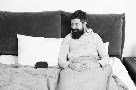 holidays and happiness concept. romantic morning at home. celebrating Saint Valentines Day. who is my valentine. happy hipster relax in bed. Heart filled with love. man feel romanceの写真素材