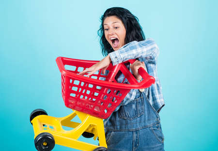 Easy and fast. happy girl go shopping. black friday sale. woman with shopping cart. purchase on...