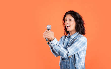 singing a song with a microphone. having a party. Happy woman with microphone. karaoke concept....
