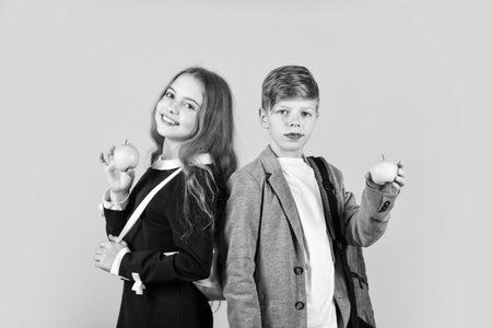 Eating apples improve learning. Little children eat apples. Small kids enjoy vitamin apples. Organic fruit. School snack. Natural food. Health and diet. Autumn harvest. Apples are in seasonの写真素材