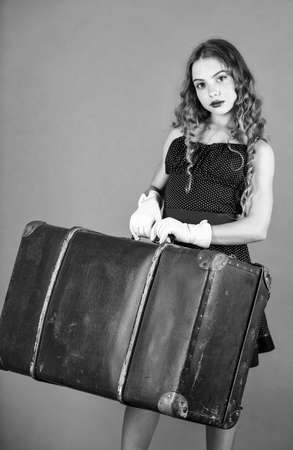 Little child carry big vintage suitcase. Vintage inspired design of bag. Accessories for vacation. Best travel bags. Cute girl ready for travel. Insurance service. Retro and vintage. All i needの写真素材
