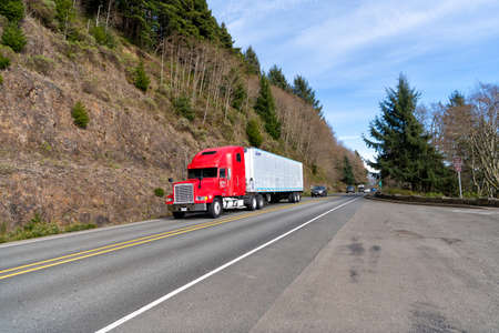 Oregon, USA - April 04, 2021: big freightliner semi truck for transporting riding on highway roadのeditorial素材