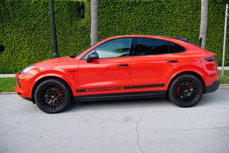Palm Beach, Florida USA - March 21, 2021: red Porsche Cayenne Coupe. side view.のeditorial素材