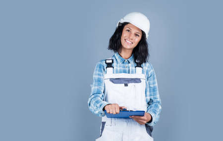 architect working with folder. female foreman on construction site. carpenter assistant wear...