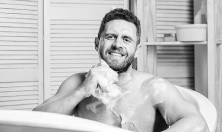 stay clean and fresh. hygiene and health. Morning shower. macho man washing in bath. personal care. Sexy man in bathroom. man wash muscular body with foam sponge. Looking just perfectの写真素材