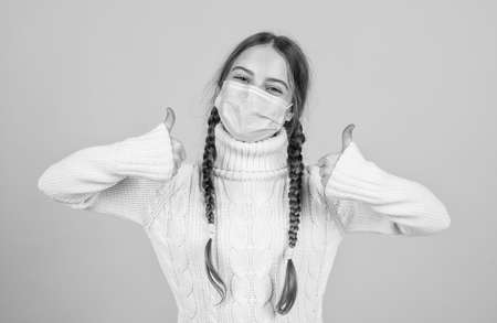 sick girl kid in protection mask during covid19 pandemic outbreak, keep safeの写真素材