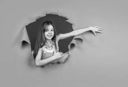 cheerful child has long hair. happy kid feeling joy and happiness. lets have fun. hairdresser concept. healthy and strong hair. transitional age. presenting product. teen girl on blue backgroundの写真素材