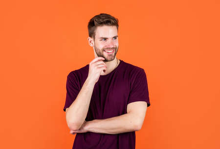 having pleasant smile. happy guy on orange background. cheerful man looking so trendy and stylish.の写真素材