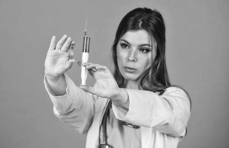 Vaccination and treatment. Painkillers concept. Modern medicines. Pain reliever injections. Anesthesia injections. Nurse with syringe. Painless Medical procedures. Adorable woman making injectionsの写真素材