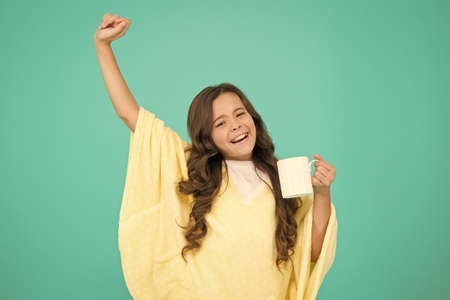 Energize morning. small kid blue background. little girl drink cocoa or milk before sleeping. cosy...