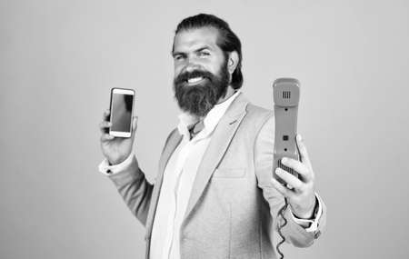 communication. true gentleman with groomed hair hold vintage telephone. nice conversation. bearded man in formalwear with modern and retro phone. elegant businessman has business talkの写真素材