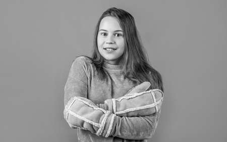 cheerful girl ready for winter activity. teen child in fur mittens and knitwear. seasonal kid fashion. christmas holiday and vacation. cute beauty keep warm. weather forecastの写真素材