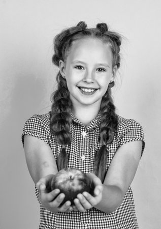 happy teen kid with apples full of vitamin picked from autumn harvest, autumnの写真素材
