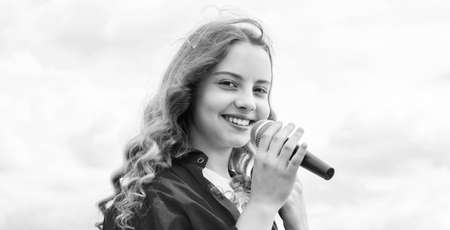 Music and life. teen girl singing song with microphone. having a party. Happy kid with microphone....