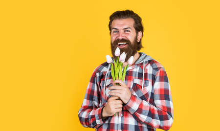 male hipster with fashionable groomed hair and beard hold tulip flowers, fathers dayの写真素材