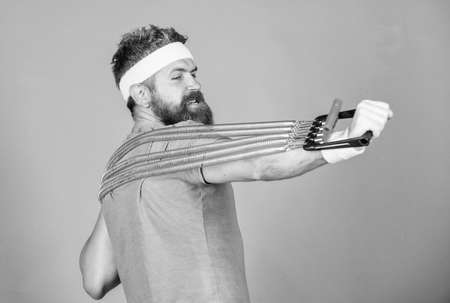 Try stretching exercise. Athlete sport instructor. Athlete workout with expander. Sportsman training...