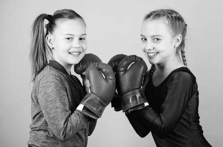 punching knockout. Childhood activity. Fitness. energy health. Sport success. Friendship. Happy children sportsman in boxing gloves. workout of small girls boxer in sportswear. Energy inside themの写真素材