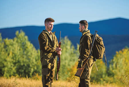 Hunting skills weapon equipment. How turn hunting into hobby. Friendship of men hunters. Army forces. Camouflage. Military uniform. Man hunters with rifle rifl gun. Boot camp. achievements of goalsの写真素材