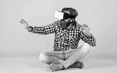 brutal bearded man wear checkered shirt having lush beard and moustache in vr glasses, virtual worldの写真素材