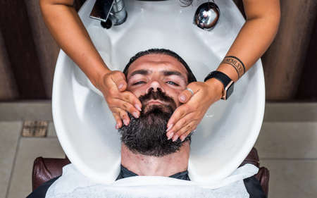 skincare. hipster washing in washbasin. male barber care. bearded man in hairdresser salon. beauty...