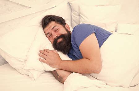 Just relaxing. bachelor feel comfortable. guy at bedroom. lazy sunday. bed time routine. smiling male spending time in room. relax lifestyle. happy bearded man in bed. wake up at morningの写真素材