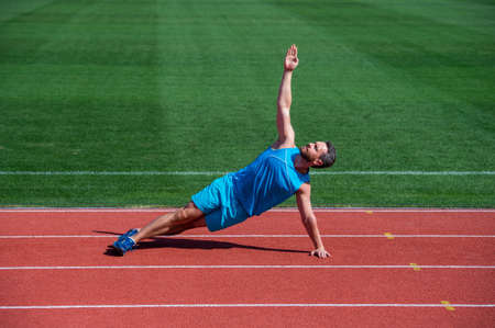 athletic muscular man warming up before training, yoga