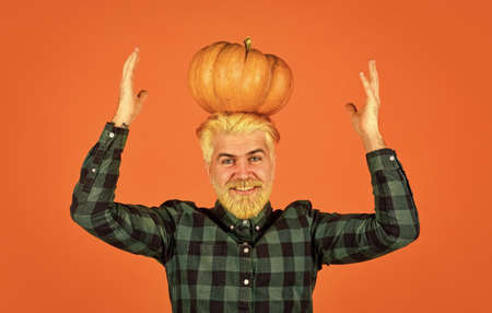 halloween. Welcome autumn. colors of fall season. Harvest time concept. happy farmer with gourd vegetable. man retro checkered shirt. vintage hipster hold pumpkin and maple leavesの写真素材