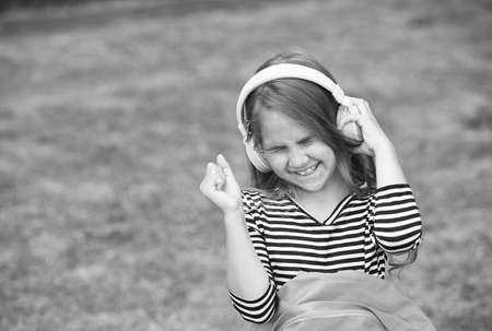 Beat of amazing rhythm. Happy kid enjoy listening to music in headphones. Music school. Musical education. Modern life. New technology. Bringing happiness through sound, copy spaceの写真素材