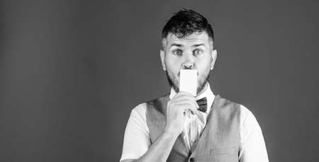 Your text here. Empty card for your contact information. Hipster with credit card. Bearded man holding business card. Businessman with bank card, copy spaceの写真素材