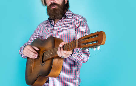 brutal caucasian hipster with beard in shirt play acoustic guitar, song writerの写真素材