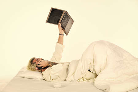 Remote job. Shopping online. Online communication. Electronic devices emit artificial blue light that can suppress release body sleep inducing hormone melatonin. Work from home. Hipster work laptopの写真素材