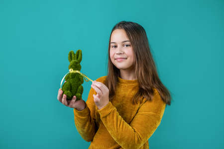 cute child girl hold easter rabbit from green grass for egg hunt, happy easterの写真素材