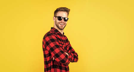 Loving new style. handsome man in sunglasses. indoor portrait of sexy european businessman. confident and calm. handsome casual man standing with beard and bristle. cheerful and stylish. copy spaceの写真素材