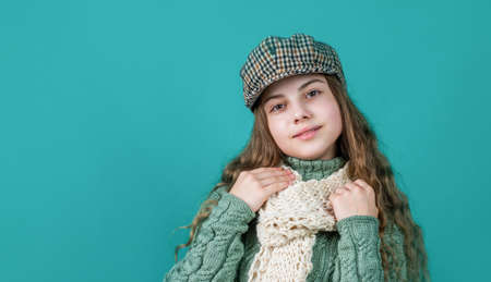 cheerful kid girl in beret and knitwear, copy space, fashionの写真素材