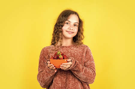 so tasty. Enjoying the moment. fruit full of vitamin. diet and dieting. organic food only. Girl with strawberry. eating strawberry for breakfast. small kid eating berries. summer time childhoodの写真素材