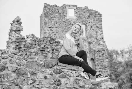 Travel destinations. Woman makeup face sit on stony ruins background defocused. Tourism concept. Explore midcentury castle ruins. Fashionable girl tourist. Vacation and travel. Travel agencyの写真素材