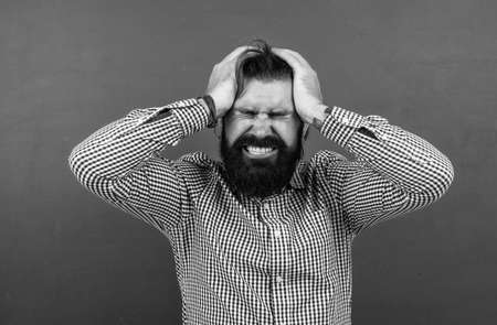 man suffering from terrible headache, pain and healthの写真素材