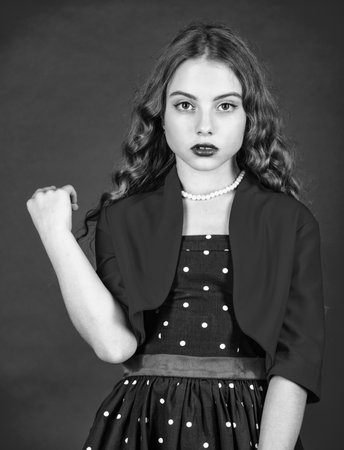 Retro fashion. Movement towards vintage fashion. Little girl makeup face curly hairstyle vintage outfit. Fast fashion essentially business model companies that manufacture products. Hairdresser salonの写真素材