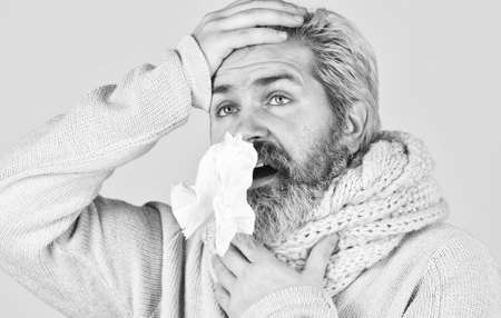 Bearded man sick. Cold flu. First symptom. Headache virus symptom. Immune response. Health care and medicines. Suffer pain. Fever and thermal regulation of immunity. More than just symptom of illnessの写真素材