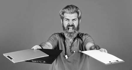 i am so angry. angry doctor with stethoscope and clipboard. therapist writing prescription. Medical nurse hold folder. pediatric healthcare. hospital or clinic. profession medicine staffの写真素材