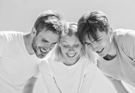 Look here. Carefree youth hang out together. See something adorable. Happiness. Group people excited look down. Woman and men happy sky background. Happiness in unity. Open mind for happinessの写真素材