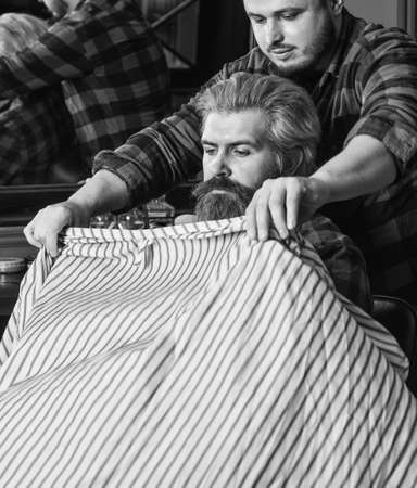 Male barber care. barber with male client. hipster with dyed beard and moustache. man want new hairstyle. male beauty and fashion. mature man at barbershop. brutal bearded man at hairdresserの写真素材