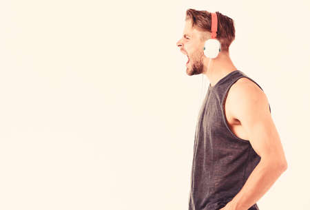 Modern earphones concept. Audio education. Audio track. Man handsome unshaven hipster listening audio file using headphones gadget. Listen music for motivation and inspiration. Audio qualityの写真素材