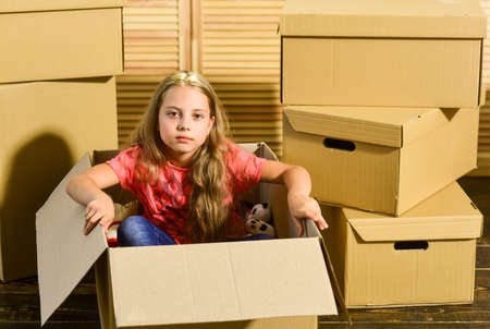 Premium quality housing. happy child cardboard box. Moving concept. new apartment. purchase of new habitation. Cardboard boxes - moving to new house. happy little girlの写真素材